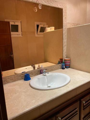 a bathroom counter with a sink and a mirror at Villa Ory in Agadir