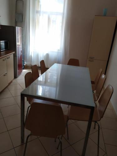 a table and chairs in a kitchen with a window at Týnská ulicka 2 - Cathedral View Apartment in Prague