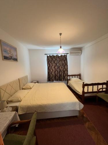 a bedroom with two beds and a couch at Apartments Boris in Budva