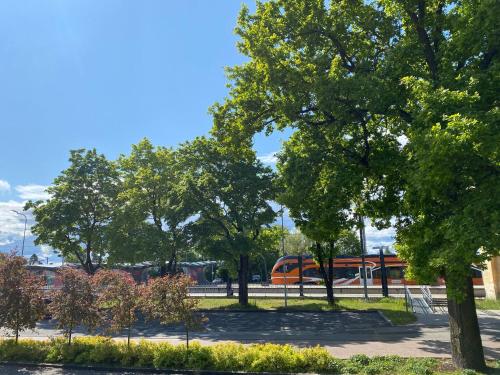 a park with trees and a train in the background at Lux Studio HOTEL in Keyla