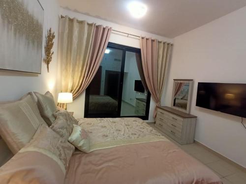 a bedroom with a bed and a large window at Escan Marina Tower Apartment in Dubai