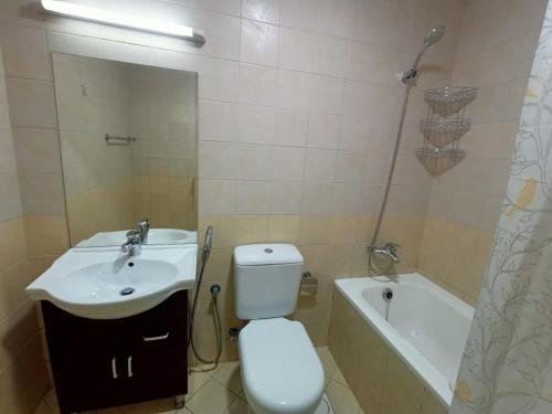 a bathroom with a sink and a toilet and a tub at Escan Marina Tower Apartment in Dubai