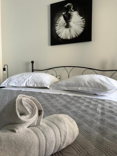 a bed with two pillows and a towel on it at Apartments Alać in Drasnice
