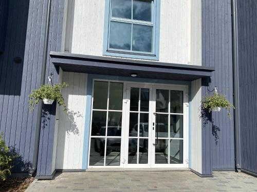 a door with two potted plants on top of it at Modern Central Apartment HOTEL in Keyla