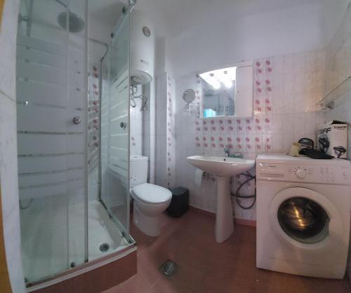 a bathroom with a shower sink and a washing machine at Kristel in Ierissos