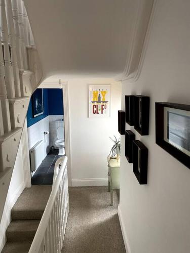 a hallway with a stairway with a room with a toilet at The Vintage retreat in Belfast