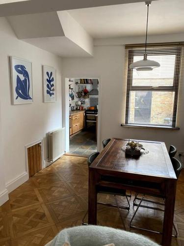 a living room with a wooden table and a kitchen at The Vintage retreat in Belfast