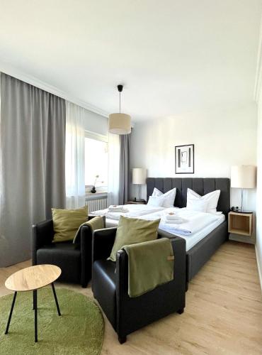 a bedroom with a bed and a couch at AHRPART Hotel in Bad Neuenahr-Ahrweiler