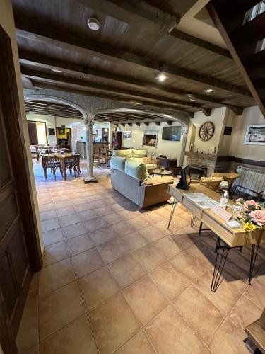 a living room with a couch and a table at Hotel rural Monasterio de Ara Mada in Santa Colomba de las Arrimadas