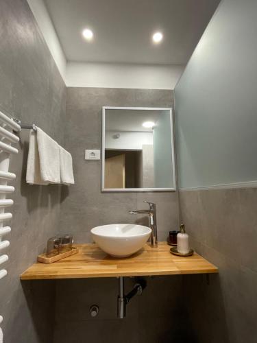 a bathroom with a white sink and a mirror at Apartment Sotlar in Izola