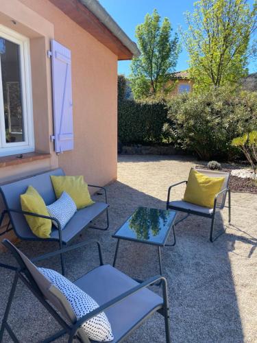 a patio with two chairs and a table at Château de Charme in Vallon-Pont-dʼArc