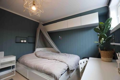 a bedroom with a bed with a mosquito net at Sjønært hus på idylliske Husøy in Tønsberg