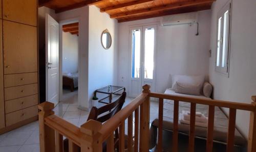a room with a staircase and a living room at Cyclops apartment in Serifos Chora