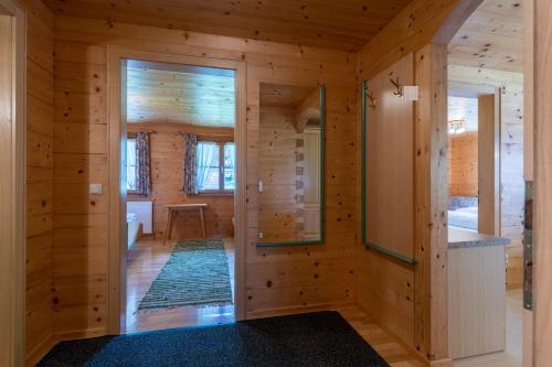 a room with wooden walls and a hallway with a mirror at Haus Maria-Theresia in Schoppernau