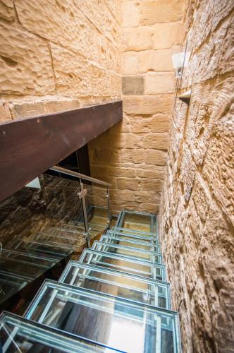 an empty staircase in a building with a brick wall at The Burrow Guest House in Tarxien