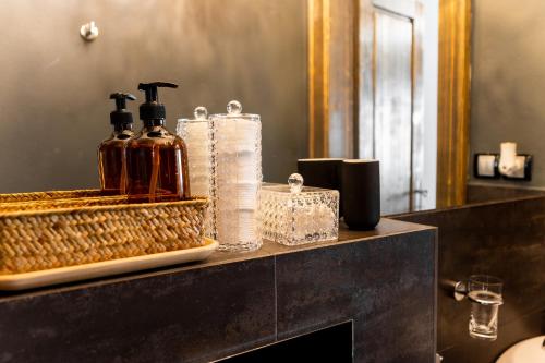 a bathroom counter with two bottles of soap and towels at Premium Apt Kosice Center 3 room with PARKING in Košice