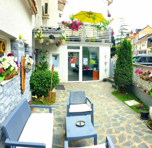 a patio with two blue chairs and an umbrella at Gago Apartments in Struga