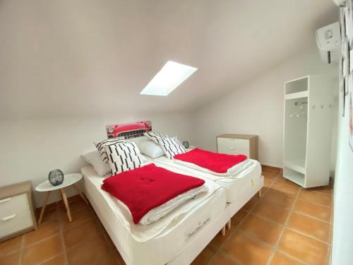 a bedroom with a bed with red and white pillows at Château de Charme in Vallon-Pont-dʼArc