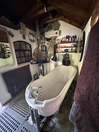 a bathroom with a white tub and a sink at Oase im Moor in Quickborn