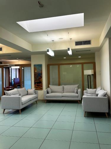 a living room with couches and a ceiling at Hotel Grecale - Venturina Terme in Venturina Terme