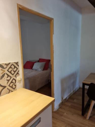 a living room with a couch and a door to a room at Gîte de la confluence in Padern