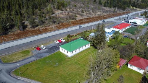 an aerial view of a house with a green roof next to a road at Bjork Guesthouse in Laugarvatn