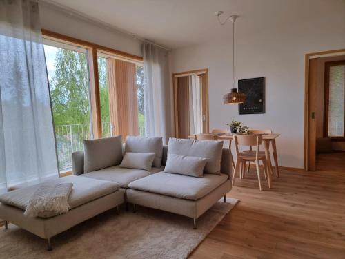 a living room with a couch and a table at Kivikatu Apartment in Rovaniemi