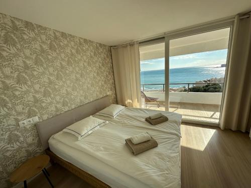 a bedroom with a bed with a view of the ocean at TOP Benalmadena in Benalmádena