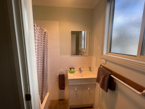 a bathroom with a sink and a mirror at Acacia Caravan Park & Holiday Units in Ararat