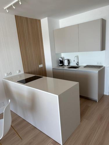 a white kitchen with a counter and a sink at TOP Benalmadena in Benalmádena