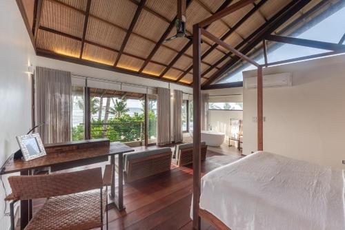 a bedroom with a bed and a desk in a room at L'Osteria Luxe Beachfront B&B in General Luna