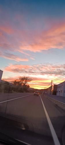 a car driving down a highway at sunset at SUNSET ROOM AT FRONT BEACH - HABITACION EN LA PLAYA en Piso compartido in Tavernes de Valldigna