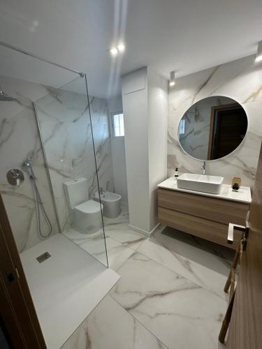 a white bathroom with a sink and a mirror at TOP Benalmadena in Benalmádena