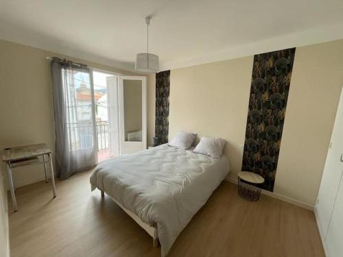 a bedroom with a bed and a large window at LG RITE Appartement avec jardin in Prades