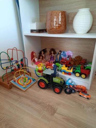 a shelf with toy trains and a toy track at Moderne 3Zimmer Wohnung, in Königsbrunn bei Augsburg in Königsbrunn