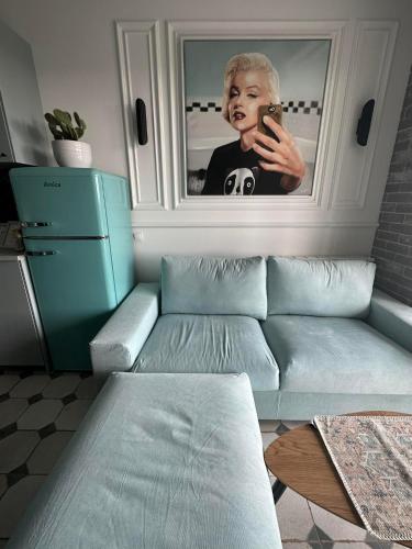 a woman talking on a cell phone in a living room at Apartament na Wzgórzu Miętowy in Łańcut