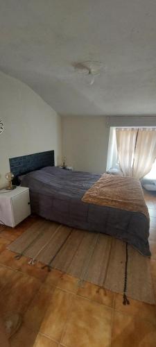 a bedroom with a large bed and a window at Casa da vila de Caria in Caria