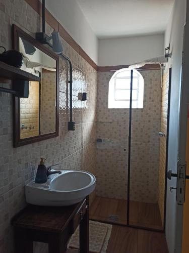 a bathroom with a sink and a shower at Centro de Gramado in Gramado