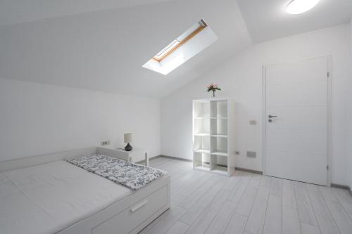 a white room with a bed and a closet at Smart Duplex in Bucharest