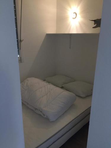 Säng eller sängar i ett rum på T2 appartement