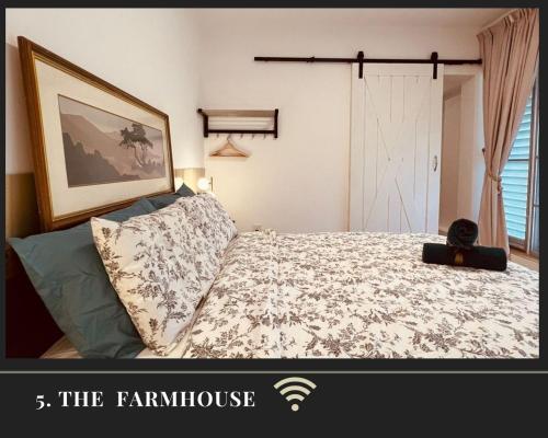 a bedroom with a bed and a picture of a farmhouse at ThatNicePlace at Selesa Hillhomes, Bukit Tinggi, Genting in Bentong