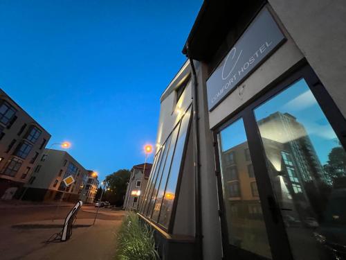 a store front with a reflection of a building at Comfort Hostel Klaipeda in Klaipėda