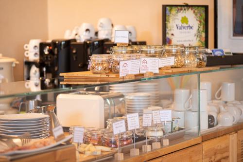a display case in a store with plates and dishes at Le Torri - Castiglione Falletto in Castiglione Falletto