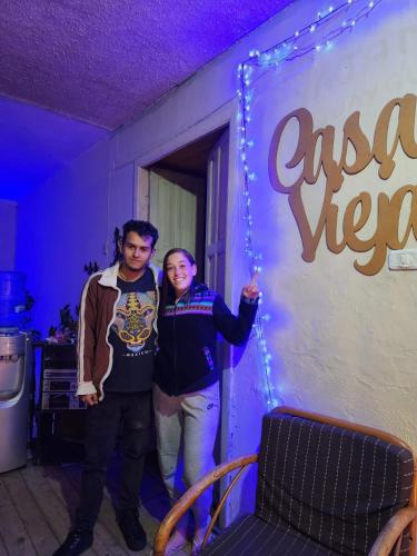 a man and a woman standing in front of a sign at CASA VIEJA del Centro Historico in Quito