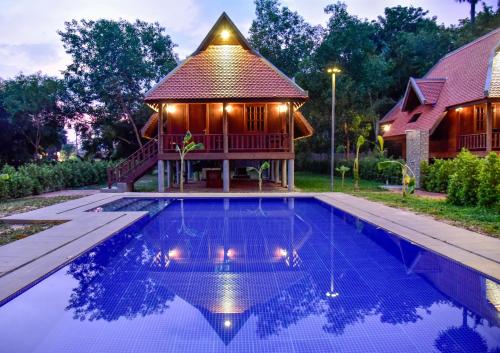 a house with a swimming pool in front of a house at Angkor Heart Bungalow in Siem Reap