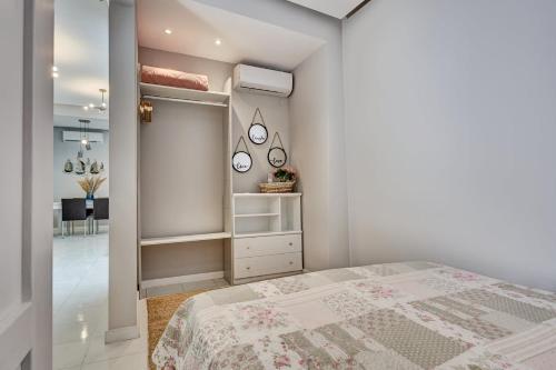 a bedroom with a bed and a walk in closet at Old Town Luxury Velvet Apartment in Rhodes Town