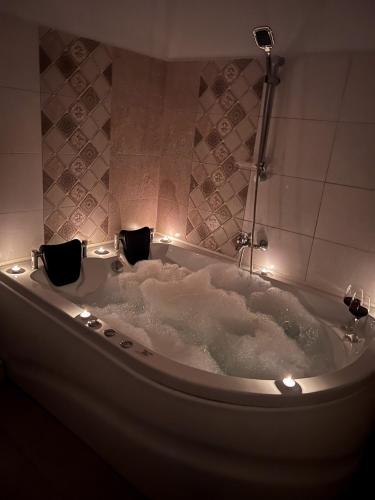a bath tub with lights in a bathroom at La Mary in Old Town in Sibiu