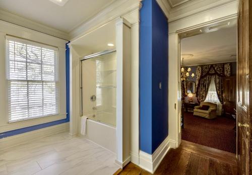 a home with blue walls and a walk in shower at Anchuca Historic Mansion & Inn in Vicksburg