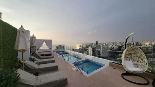 a balcony with a swimming pool on a building at Lovely Aparment OceanView Barranco1809 in Lima