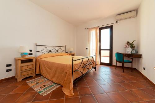 a bedroom with a bed and a table and a chair at SEI - Isola Lunga in Marsala